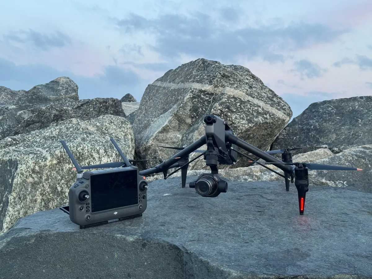 DJI Inspire 3 with the Zenmuse X9 gimbal and its RC Plus controller set up on the granite breakwater at Fremantle at dawn